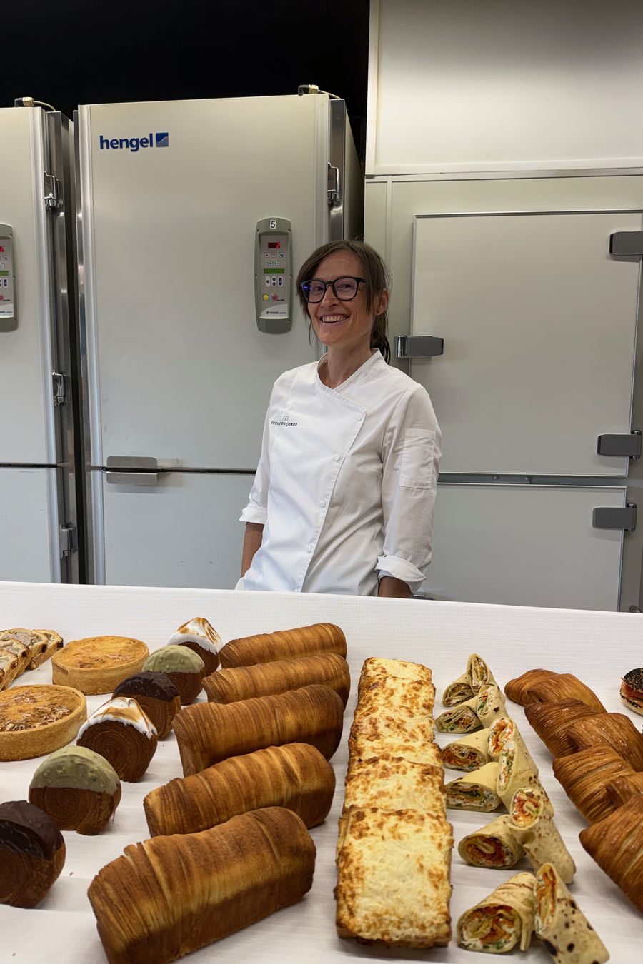 Nadya Denisenko at the bench behind a table of viennoiserie.